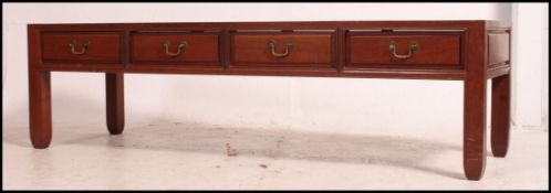 A 20th century Chinese hardwood coffee table of rectangular form having four fitted drawers beneath.