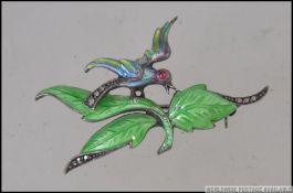 A silver 935 vintage enamel ladies brooch in the form of a humming bird with leaves having