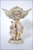A 19th century Meissen / Sitzendorf porcelain centrepiece having large fret worked bowl over lady