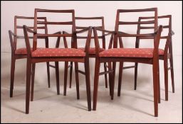 A set of 5 stunning Niels Moller type Danish teak 1970's carver dining chairs being raised on