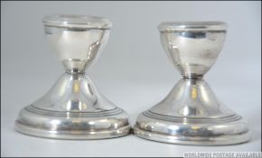 A pair of stub filled silver hallmarked candle sticks having a Birmingham assay mark makers mark