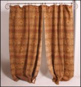 A pair of heavy long fully lined tapestry curtains along with a metal curtain pole and hooks.