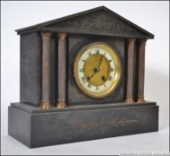 A 19th century marble / slate eight day mantle clock having double column supports with classical