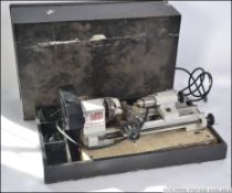 A vintage cased 20th century hobbiest lathe with attachments etc please see images.