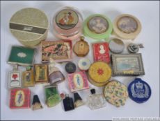 A collection of vintage ladies vanity items to include powder puffs (one Tweed ) rouge, soaps.