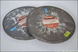 Two vintage 16mm film cans believed to contain parts one and two for Disney's Dumbo II,