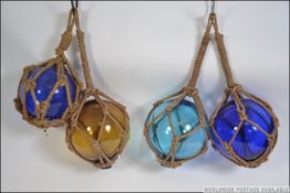 4 large vintage glass floats - coloured glass to include blue, greens etc all in rope twine.