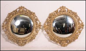A good large mid century pair of circular convex fish eye mirrors set within resin painted rococo