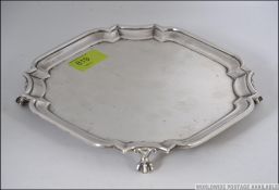 A silver hallmarked salver raised on ball and claw feet by Pairpoint Bros -John & Frank Pairpoint-