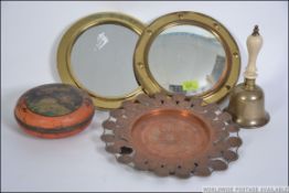 A brass framed convex mirror together with another brass porthole mirror,