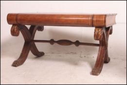 A 20th century coffee table in the form of a book having spine drawer and raised on a mahogany