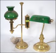 A 20th century antique style bankers lamp with green glass shade together with a brass and green