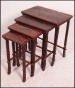 An early 20th century Chinese laquered quartetto nest of tables each with chinoserie decoration.