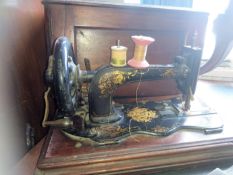 A Victorian mahogany cased Singer sewing machine. The case with handles ( see illustrations ).