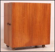 A 1970's retro Danish metamorphic teak drinks cabinet.