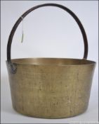 A large Victorian heavy set brass jam pan with cast iron handle.