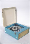 A vintage two tone vinyl covered four speed portable record player by Fidelity having a four speed
