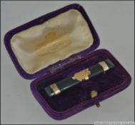 A stunning ladies Jade bar brooch being mounted with 9ct gold having the New Zealand fern with