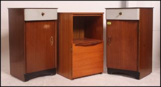 A pair of retro mid 20th century bedside tables / cabinets having a fabric covered drawers above
