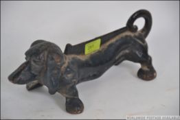 A possible early 20th century cast iron boot scrap in the form of a Dachshund dog.