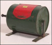 A mid 20th century scratch built tombola being constructed from a empty oil can and then painted