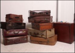 A good stack of several vintage and retro 20th century leather and other suitcases various makers