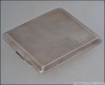 A silver hallmarked Mappin & Webb cigarette case having geometric engine turned stylisation bearing