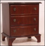 A Georgian design mahogany serpentine front bedside chest of drawers, fitted three drawers.