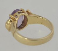 A 9ct gold hallmarked cloudy amethyst ladies dress ring having a bucke style ring.