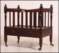 A Regency style mahogany canterbury magazine rack with single drawer under sectional top.