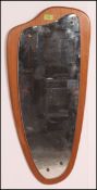 A 1970's retro teak Atomic style wall mirror of angular form with teak back plinth and frameless
