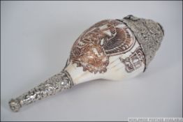 A Chinese Tibetan silver mounted conch shell.
