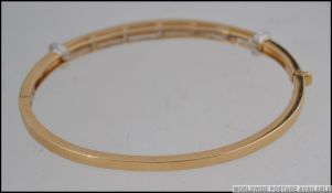 A hallmarked 18ct gold and diamond bracelet bangle with approx 150pts of cushion cut diamonds in a