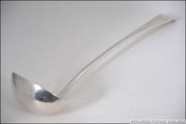 A large George III silver hallmarked ladle having London assay marks,