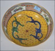 A Chinese famille / juane rose bowl with decorative yellow panel work,