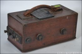 A vintage 20th century oak cased hand cranked A Megger resistance tester,