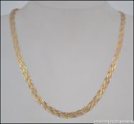 A 14ct gold snake linked ladies necklace intertwined with rose gold, white gold and yellow gold.