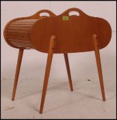 A 1950's mid century blond wood tambour top sewing box with appointed interior and raised on