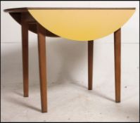 A retro / vintage 1950's Kandya drop leaf dining table having a yellow formica top raise on beech