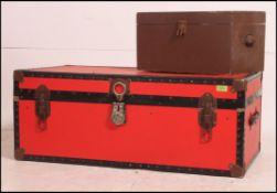 A retro style red canvas bound 20th century steamer trunk with hinged centre and black bindings