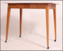 A stunning retro farmhouse style kitchen table with a floral melamine surface above a single drawer