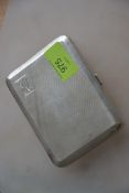 A silver hallmarked cigarette case having an engine turned geometric pattern,