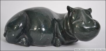 A large Chinese carved marble Jade coloured figurine of a hippopotamus - hippo in a seated position
