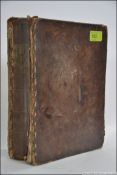 An early King James, 18th - 19th century ? bible set within thick leather hand stitched binding.
