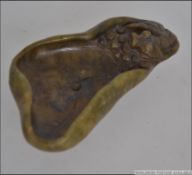 An unusual Chinese carved jade pin dish having a carving to one end of Koi Carp laying eggs.