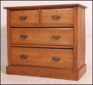 An Edwardian satin walnut two over two chest of drawers.