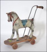 A late 19th / early 20th century British made push along horse,