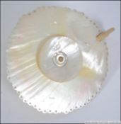 A 19th century mother of pearl shell chamberstick candle.
