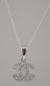 A Chanel style silver and CZ adorned interlocking pendant and necklace.