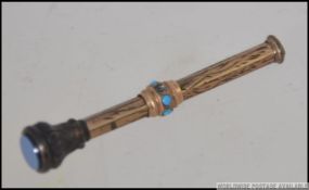 A 9ct gold metamorphic propelling pencil inset with turquoise, weight 2.